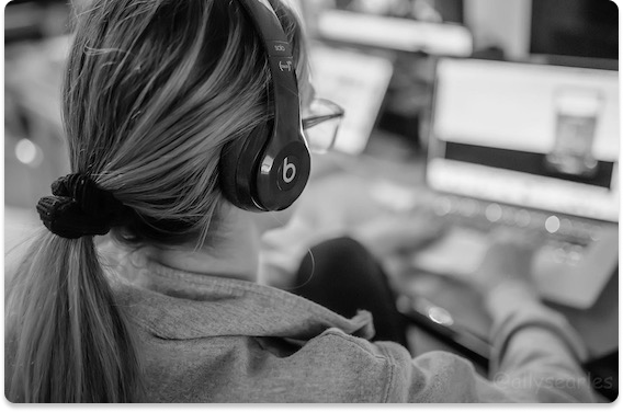 Black and white photo of me working on the computer, focused and immersed in my work.